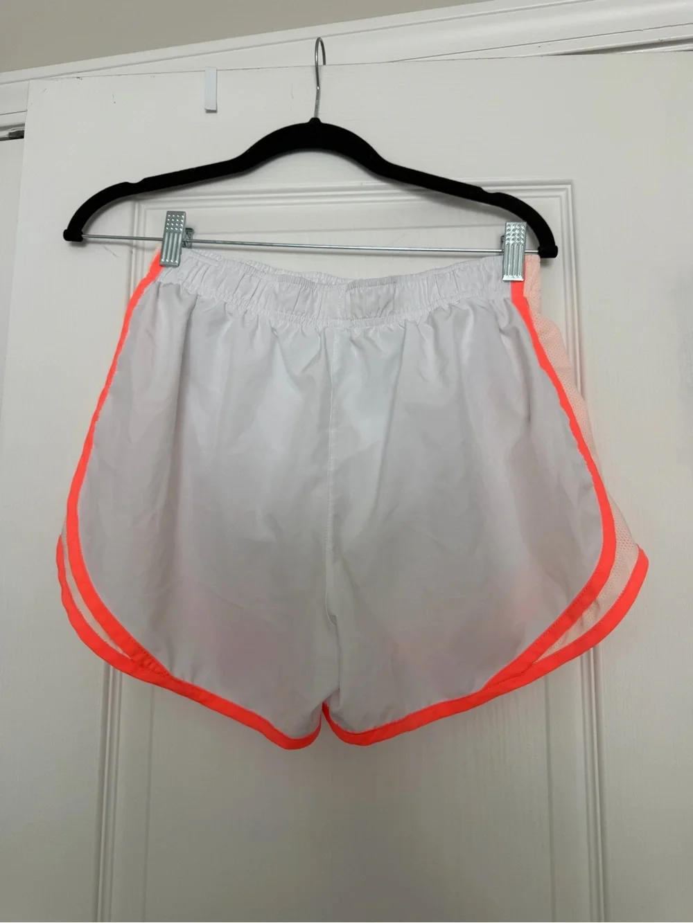 Nike Dri-Fit white running shorts with orange trim, size M